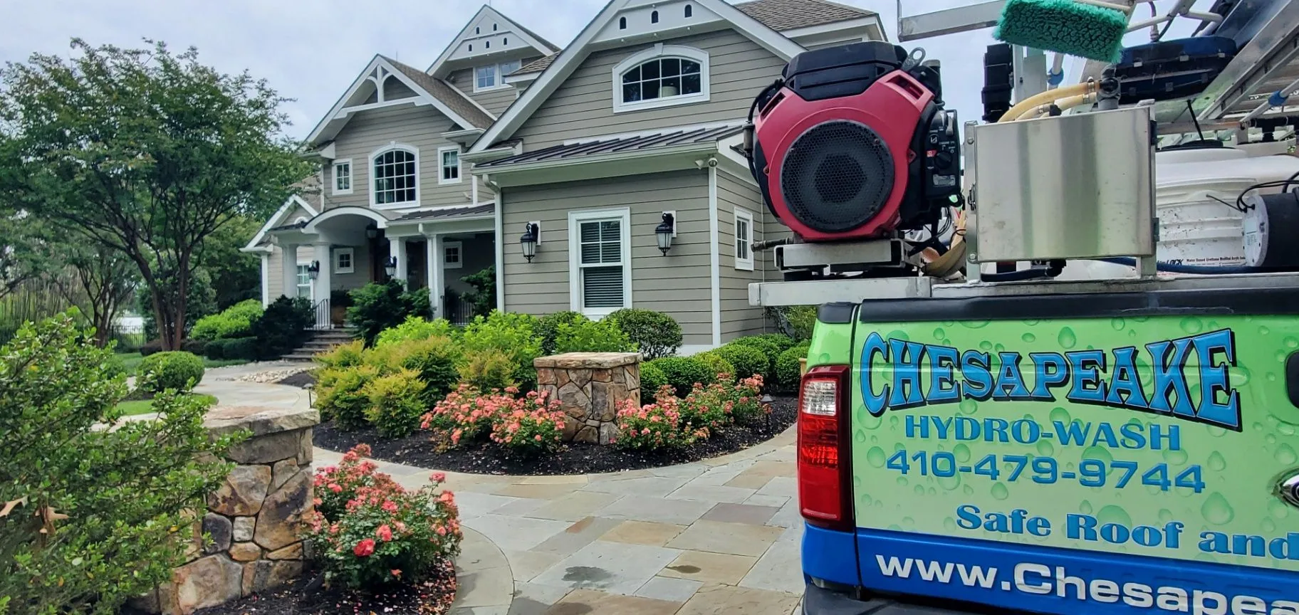 Chesapeake Hydro-Wash equipment set up at the front of a landscaped Maryland home